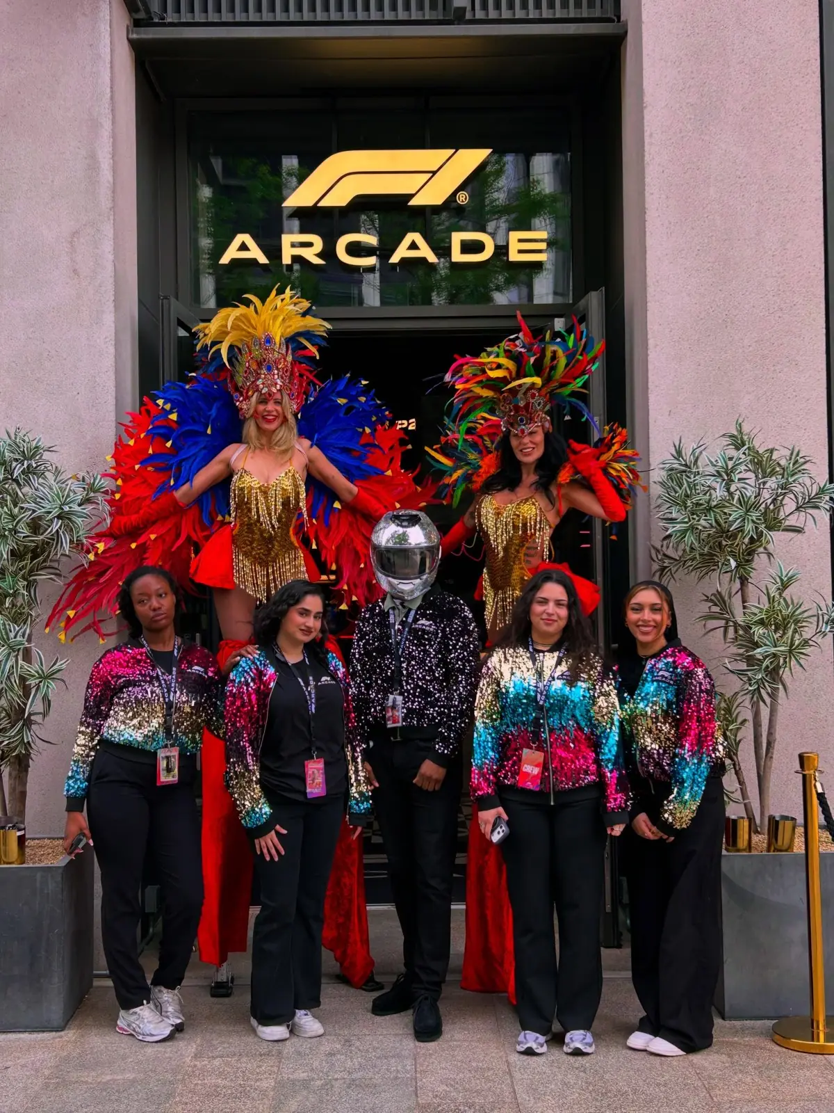 Lamour performers in carnival costumes outside an arcade