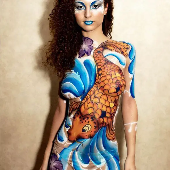 Model with a full body painting of a koi carp design