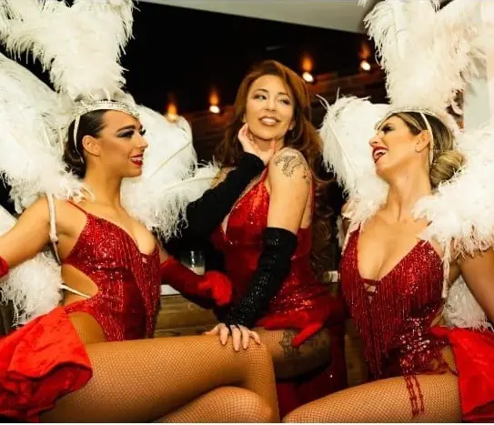 Cabaret dancers in red and white feathers