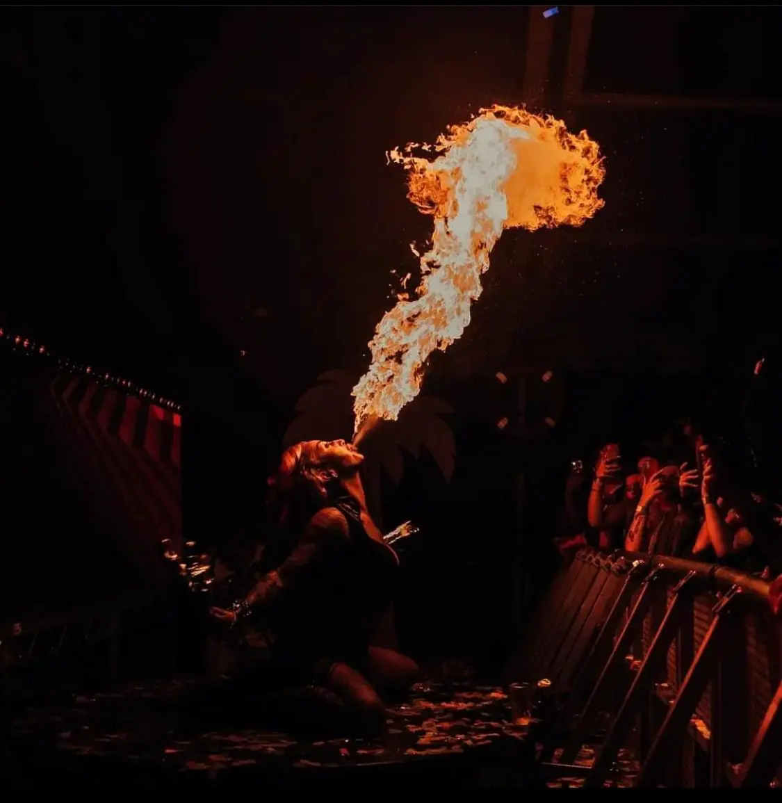 Fire breather sending a plume of flame into the air