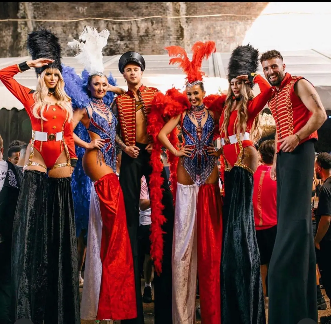 Stilt walkers in red and white circus costumes